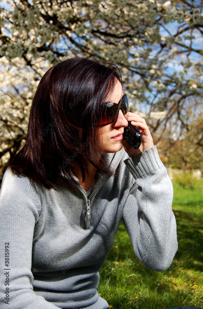 Portrait of a brunette nice girl in a park.