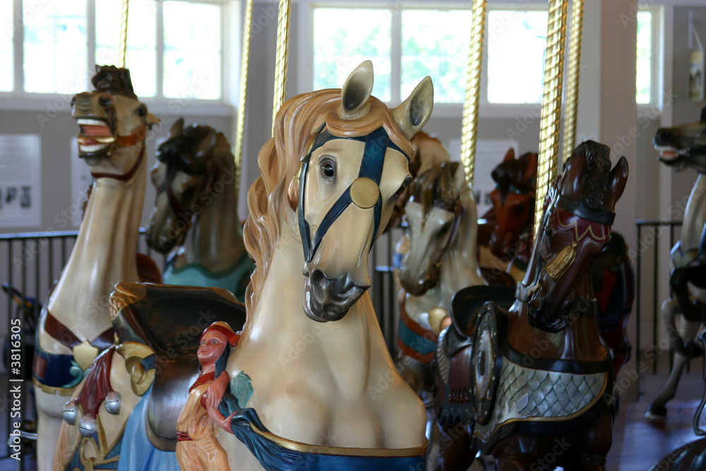 A white horse on an merry-go-round