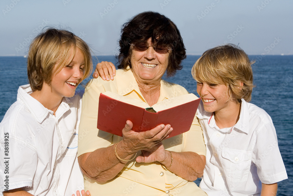 grandmother reading to happy smiling grandchildren grandmother reading to happy smiling grandchildren