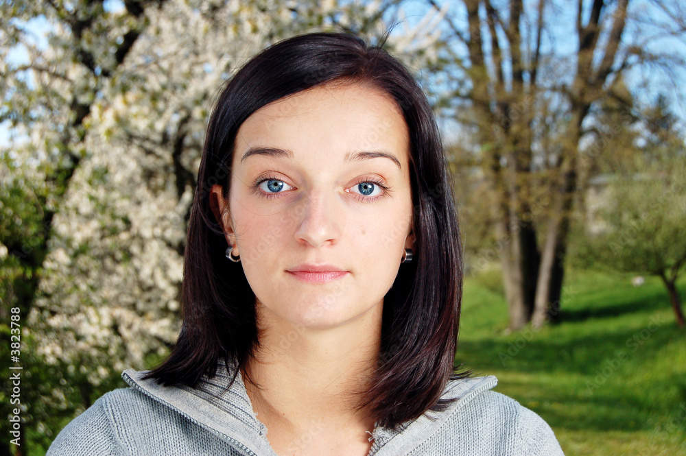 Portrait of a brunette nice girl in a park.