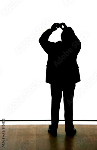 Silhouette of a man taking a picture with a P/S camera