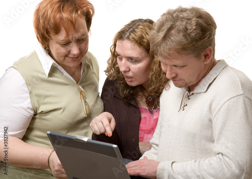 man and two women with laptop on white background