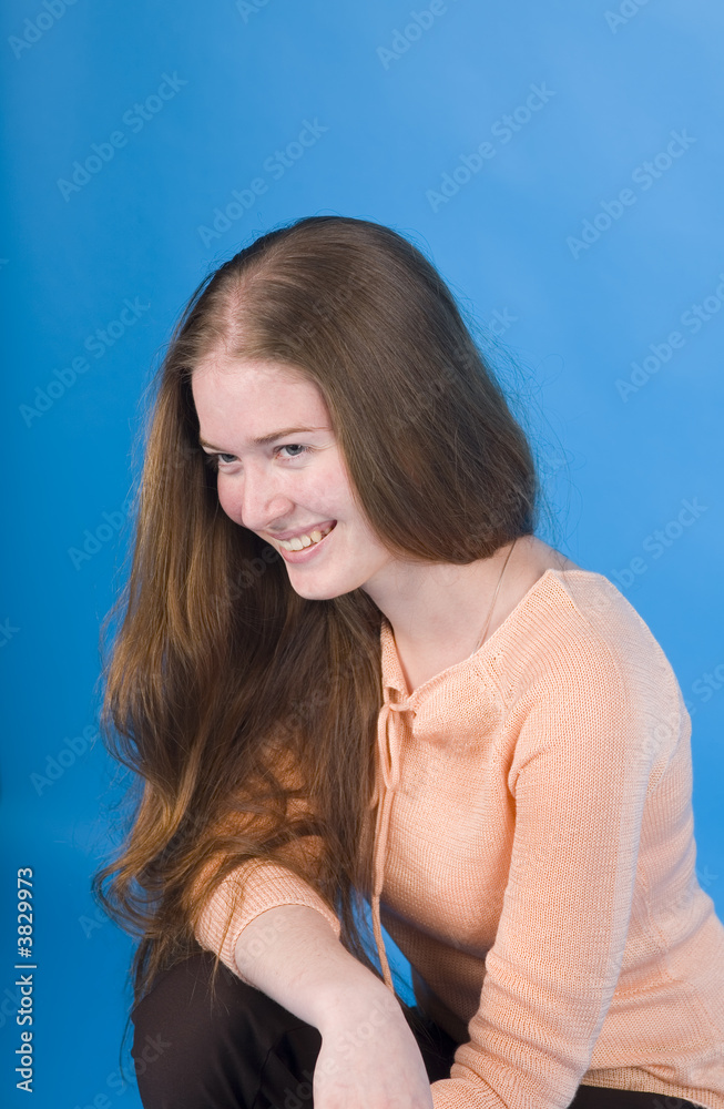 Portrait of the smiling girl on a blue background Portrait of the smiling girl on a blue background