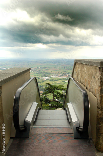 An escalator perched above the Italian countryside.