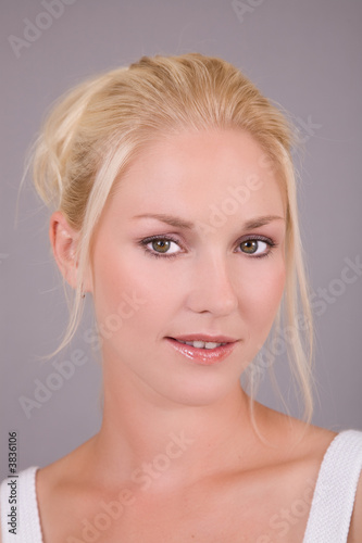 Beautiful blond woman on gray background 