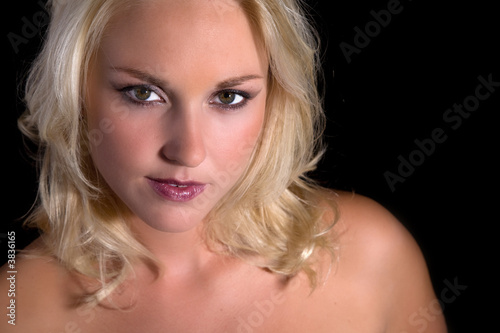 Beautiful blond woman on black background portrait
