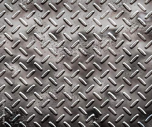 a very large sheet of rough black diamond plate with pits  photo