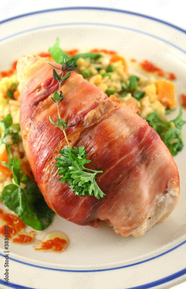 Chicken wrapped in prosciutto on pumpkin and rocket risotto. Chicken wrapped in prosciutto on pumpkin and rocket risotto.