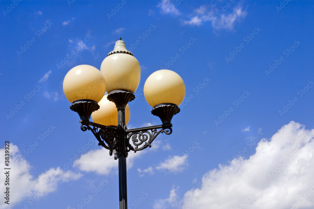 Street lantern on a background of the blue sky