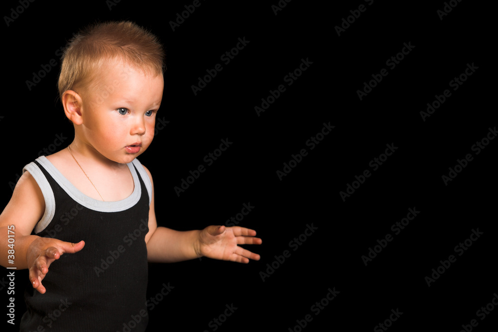 Young going child isolated on the black background Young going child isolated on the black background