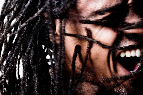 Valokuva man with dreadlocks screams through life