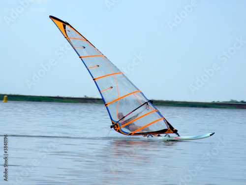 windsurfer on waves of a gulf in the afternoon © Sergey Sukhorukov