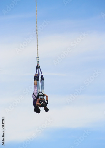Couple bungee jumping off a tower