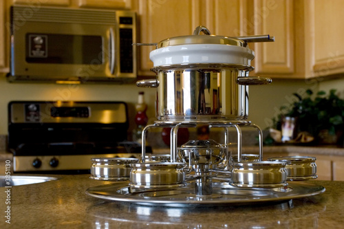 Stainless steel fondue set on the kitchen counter