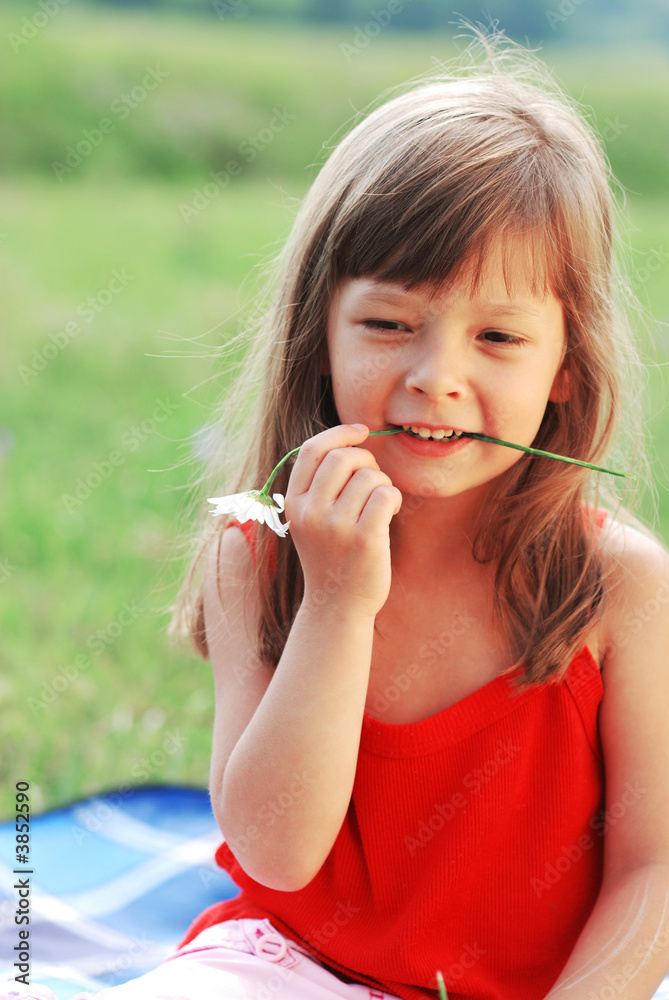 Little cute girl with flower outdoors Little cute girl with flower outdoors