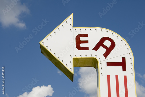 A three-dimensional metal EAT sign in a sans-serif typeface. photo