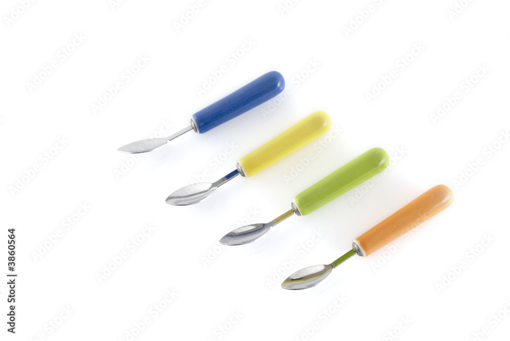 four modern colored spoons in a row four modern colored spoons in a row