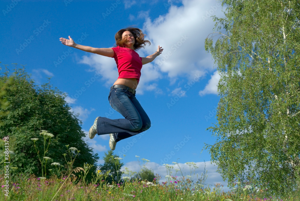 Beautiful lady jumping in summer landscape Beautiful lady jumping in summer landscape