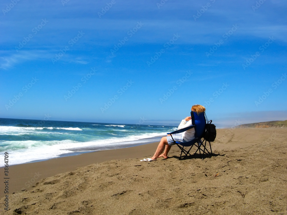 Ocean view with single person seating on beach and relaxing Ocean view with single person seating on beach and relaxing