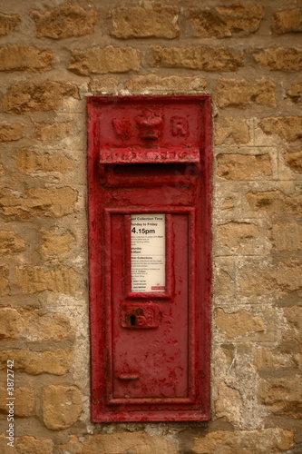 Victorian letterbox in wall of house in English village 