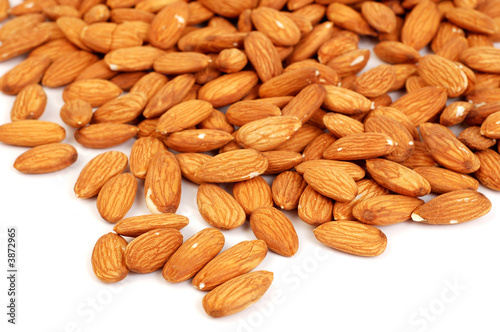 A group of shelled almond nuts on a white background.