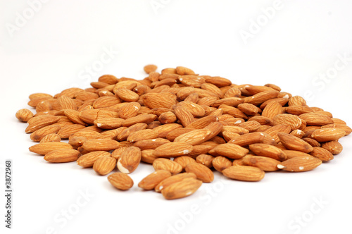 A group of shelled almond nuts on a white background.