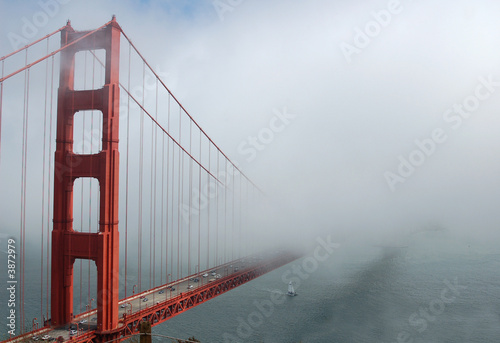 The Golden Gate Bridge in a heavy fog.