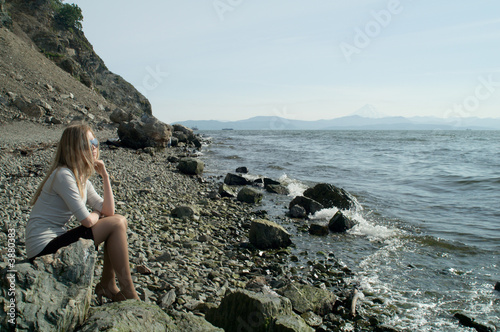beautiful girl facing the sea on a vacant beach