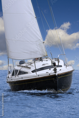 Closeup of little sailing yacht, front view.