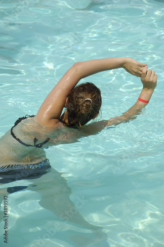 Girl in pool doing aerobic