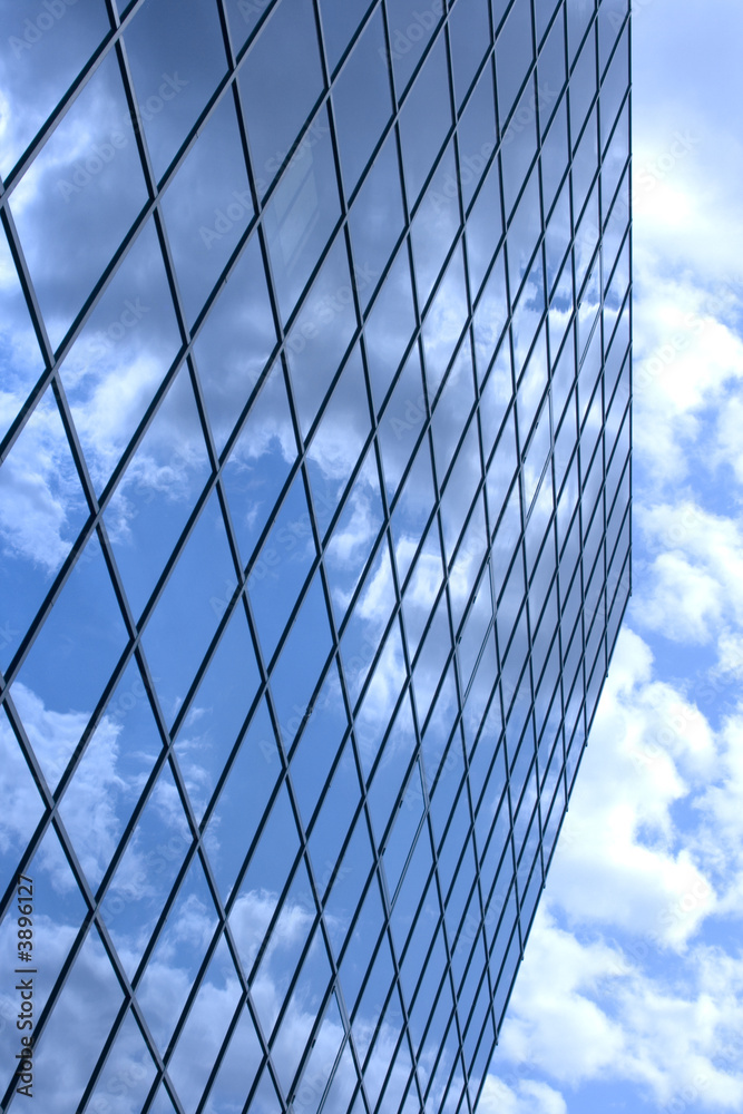 Clouds reflecting on a glass building