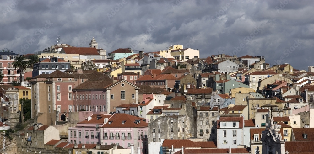 Rooftops of old district in Lisbon, Portugal clouds