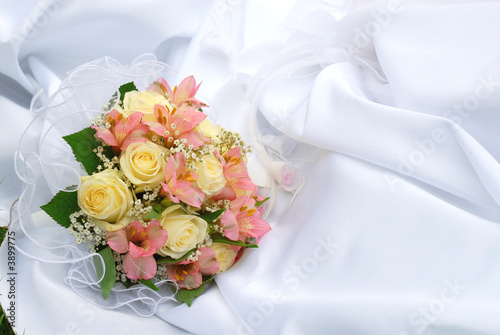 Wedding bouquet on a background of dress of the bride
