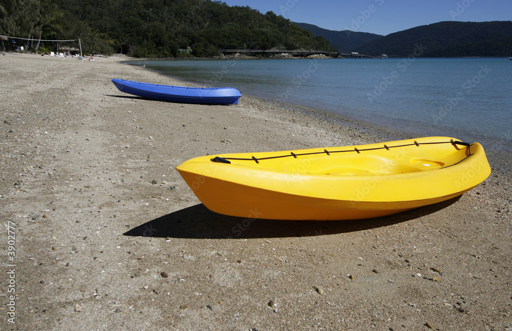 colorful kayaks on beach by turquoise waters colorful kayaks on beach by turquoise waters
