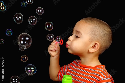 Valokuvatapetti Boy blowing soap bubbles