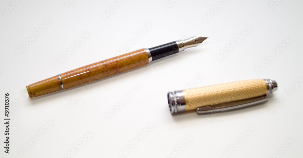 old golden pen with cap over white background old golden pen with cap over white background