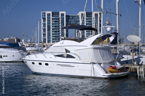 Luxurious motor yacht docked in marina © Aradan