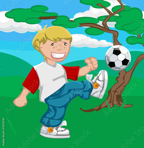 A young boy happily playing soccer