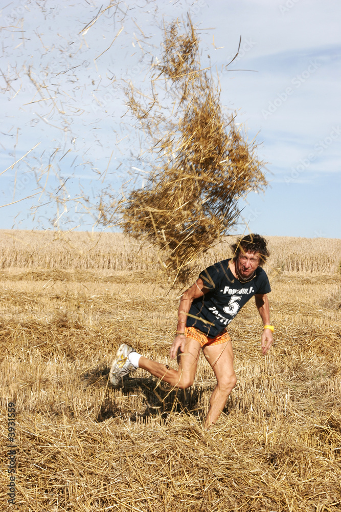 a man who throws straw in with the top of him