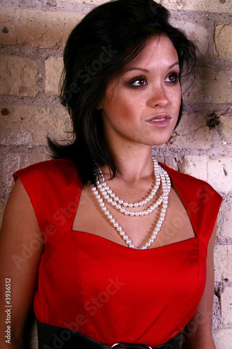 Asian woman on a brick wall  textured background.