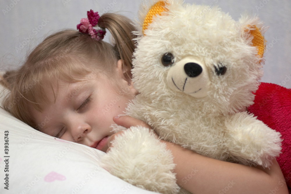 A little girl sleeping with a toy