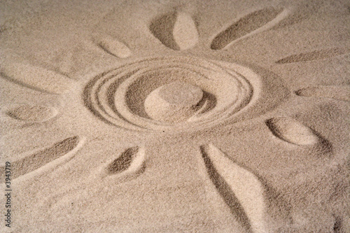 draw of a sun on sand