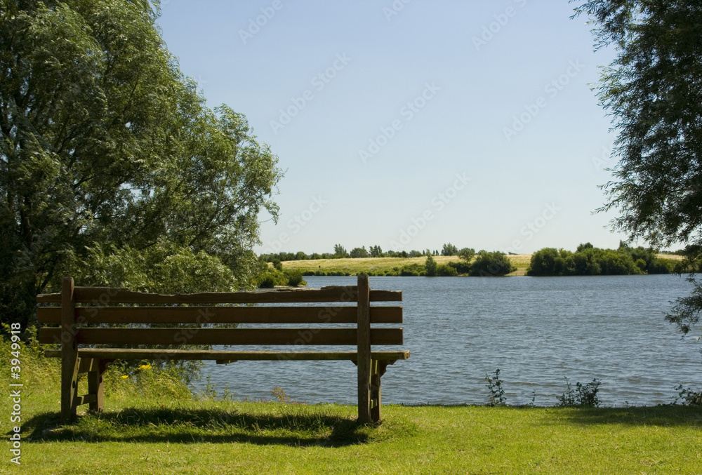 Old wooden bench by lakeside Old wooden bench by lakeside