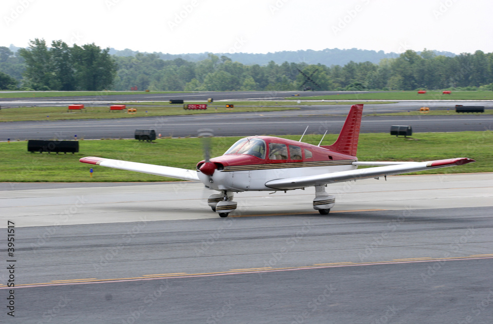 Fototapeta premium Red and White Plane on Runway