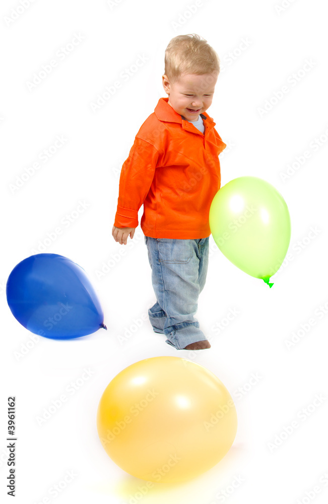 Little boy white background playing with balloons.