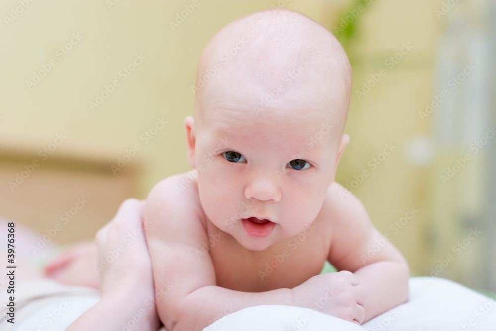 Baby resting on mother's chest and look at camera Baby resting on mother's chest and look at camera