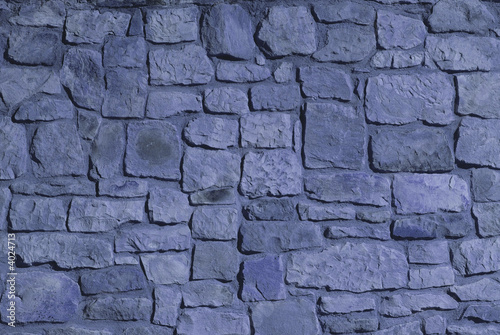 Stone wall. Artificial blue light.
