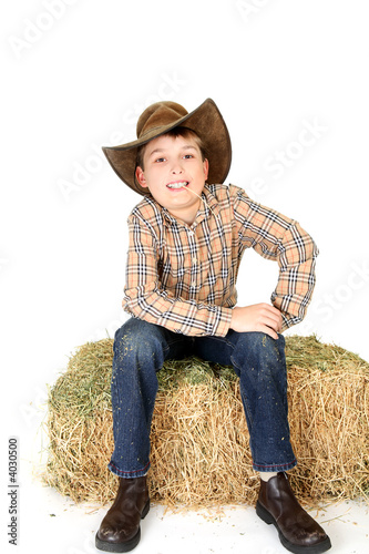 Boy chewing on a piece of straw