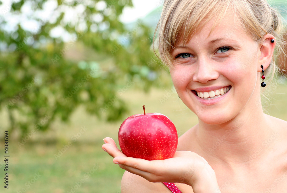 Young woman holding apple, smiling Young woman holding apple, smiling