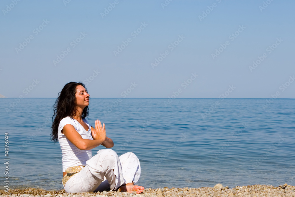 young woman meditation in the beach
